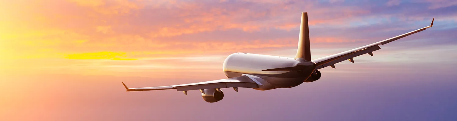 Plane Taking Off Into Sunset