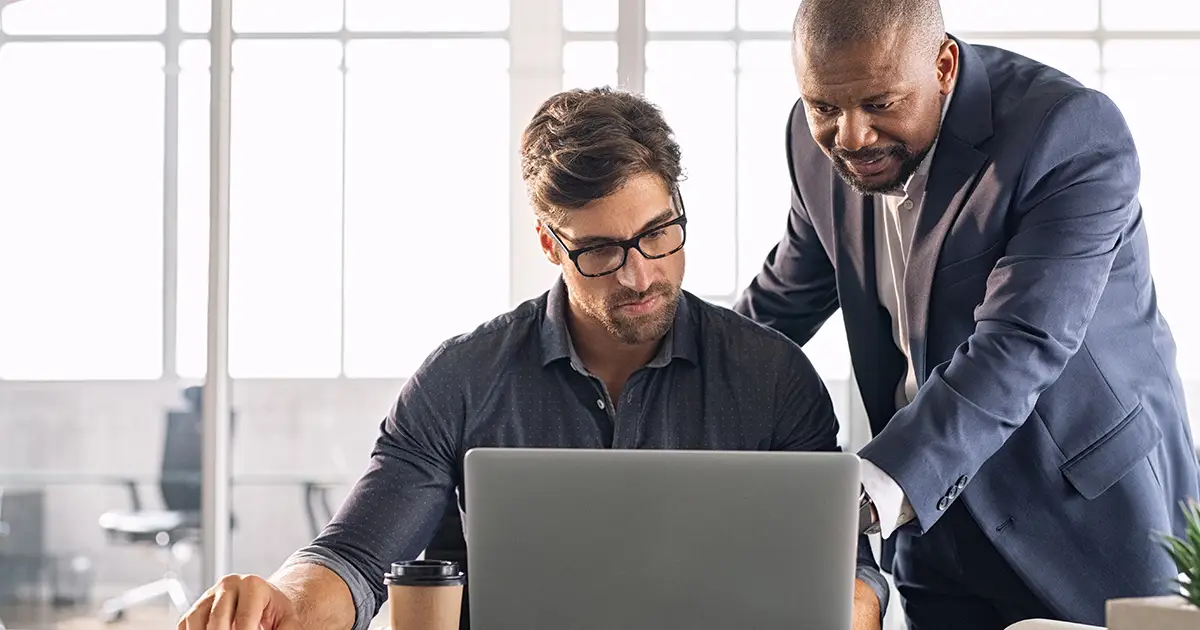 2 people looking at a computer screen